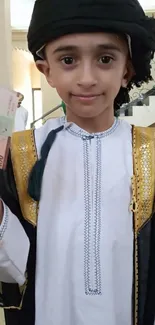 Child in traditional attire holding currency notes, smiling warmly.