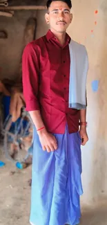 Person in traditional red and blue attire standing indoors as mobile wallpaper.