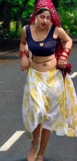 Woman in traditional attire on a road, showcasing cultural fashion.