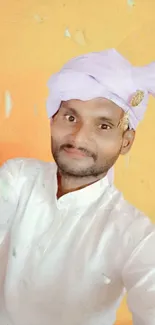 Man in traditional attire with yellow background.