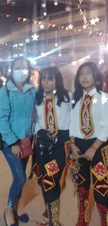 Traditional attire at night market, festive stars overhead.