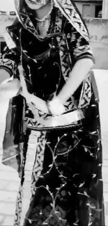 Traditional dancer in black and white attire, performing elegantly.