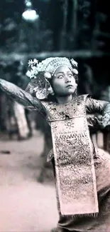 A grayscale image of a traditional dancer in cultural attire.