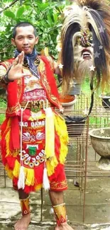 Indonesian dancer in vibrant costume holding a traditional mask.