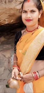 Woman in orange traditional sari with henna and accessories.