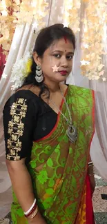 Woman in vibrant green sari with ornate jewelry