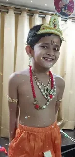 Child in traditional attire smiling brightly.