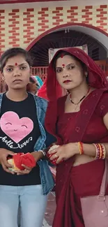 Two women in traditional festive attire during a cultural gathering.