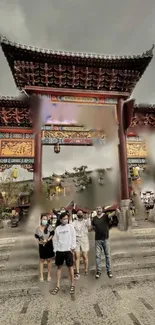 Visitors at a traditional gate in a cultural setting with vibrant architecture.