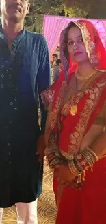 Couple in traditional Indian attire at a festive celebration.