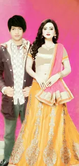 Couple in traditional Indian attire on a vibrant pink background.