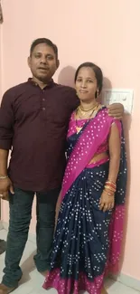 Couple in Indian traditional attire with vibrant colors.