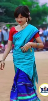 Woman in vibrant blue saree with stylish design.