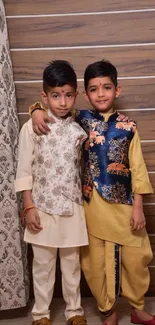 Two children in traditional outfits with rich patterns.