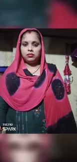 Woman in a red shawl with traditional decor background.