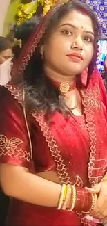 Woman in a traditional red saree portrait.