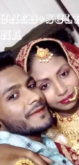 Traditional Indian wedding couple portrait with intricate jewelry.