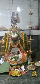 Traditional worship shrine adorned with flowers and offerings.