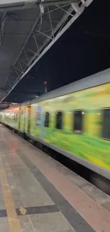 A vibrant green train speeding through a night station.