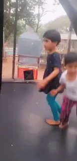 Kids having fun on a trampoline in an outdoor setting.