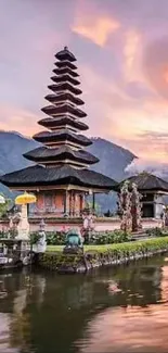 Bali temple at sunset with reflection on water.