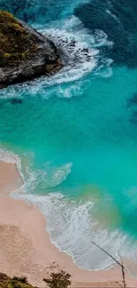 Aerial view of turquoise waters meeting a sandy beach.