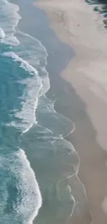 Aerial view of a tranquil beach with gentle waves and sandy shores.