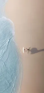 Aerial view of a tranquil beach with waves gently touching sandy shores.