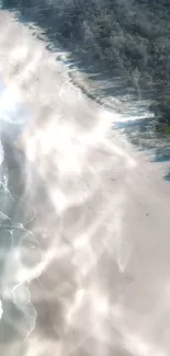 Aerial view of a sandy beach with crashing waves and a tranquil coastline.