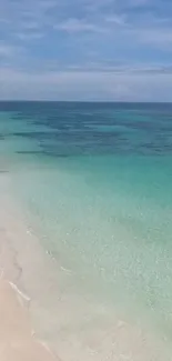 Turquoise sea and white sandy beach wallpaper.