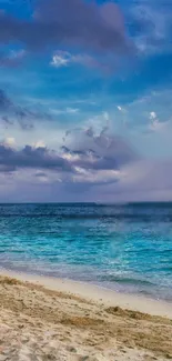 Tranquil beach with a vibrant blue sky and ocean under a sunset glow.