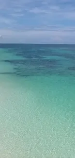 Serene turquoise beach with clear blue sky.