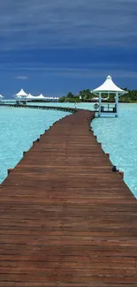 Wooden pier extending over turquoise waters with a blue sky backdrop.