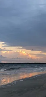 Tranquil sunset at a serene beach with ocean waves and colorful sky.