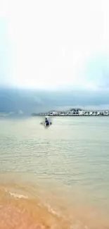 A serene beach with bungalows over calm turquoise water under a cloudy sky.