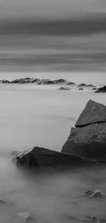 Black and white rocky shoreline with smooth water.