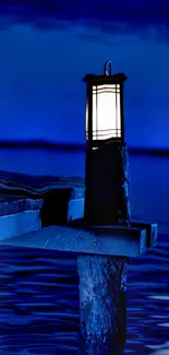 Serene dock with glowing lantern over deep blue water at night.