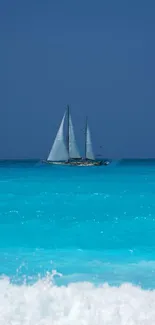 Sailboat gliding on a tranquil blue sea under a clear sky.