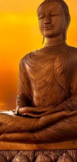 Buddha statue with orange sunset background.