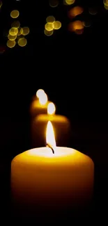 A serene image of glowing candles with a dark background.