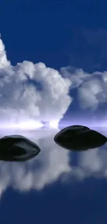 Tranquil clouds reflecting on calm water with stones in foreground.