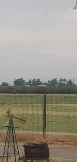 Tranquil countryside with windmill and field