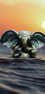 Elephant statue in ocean with sunset backdrop creating a serene wallpaper design.