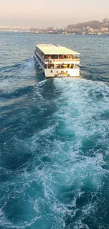 Ferry sailing on vibrant blue sea with scenic backdrop.