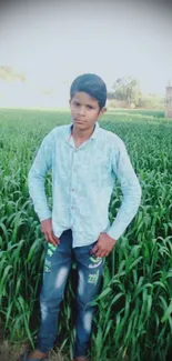 Person standing in lush green field with serene rural backdrop.