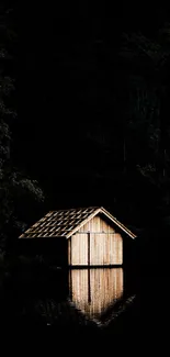 Rustic cabin reflecting on a dark lake in a tranquil forest setting.