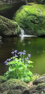 Serene forest waterfall with green moss and purple flowers.