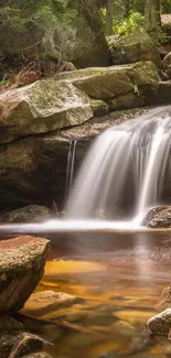 Mobile wallpaper of a tranquil waterfall in a lush forest setting.