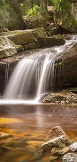 Tranquil waterfall flowing over rocks in a lush forest setting.