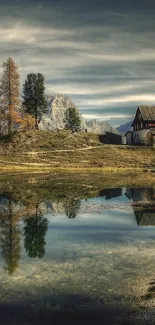 Beautiful lakeside cabin with autumn colors and reflections under a vibrant sky.